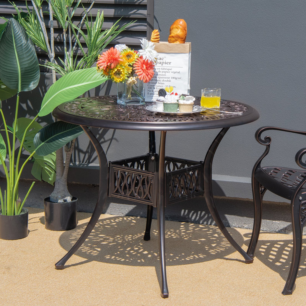 Brown 36-inch round outdoor patio dining table with umbrella hole, ideal for bistro or outdoor dining spaces.