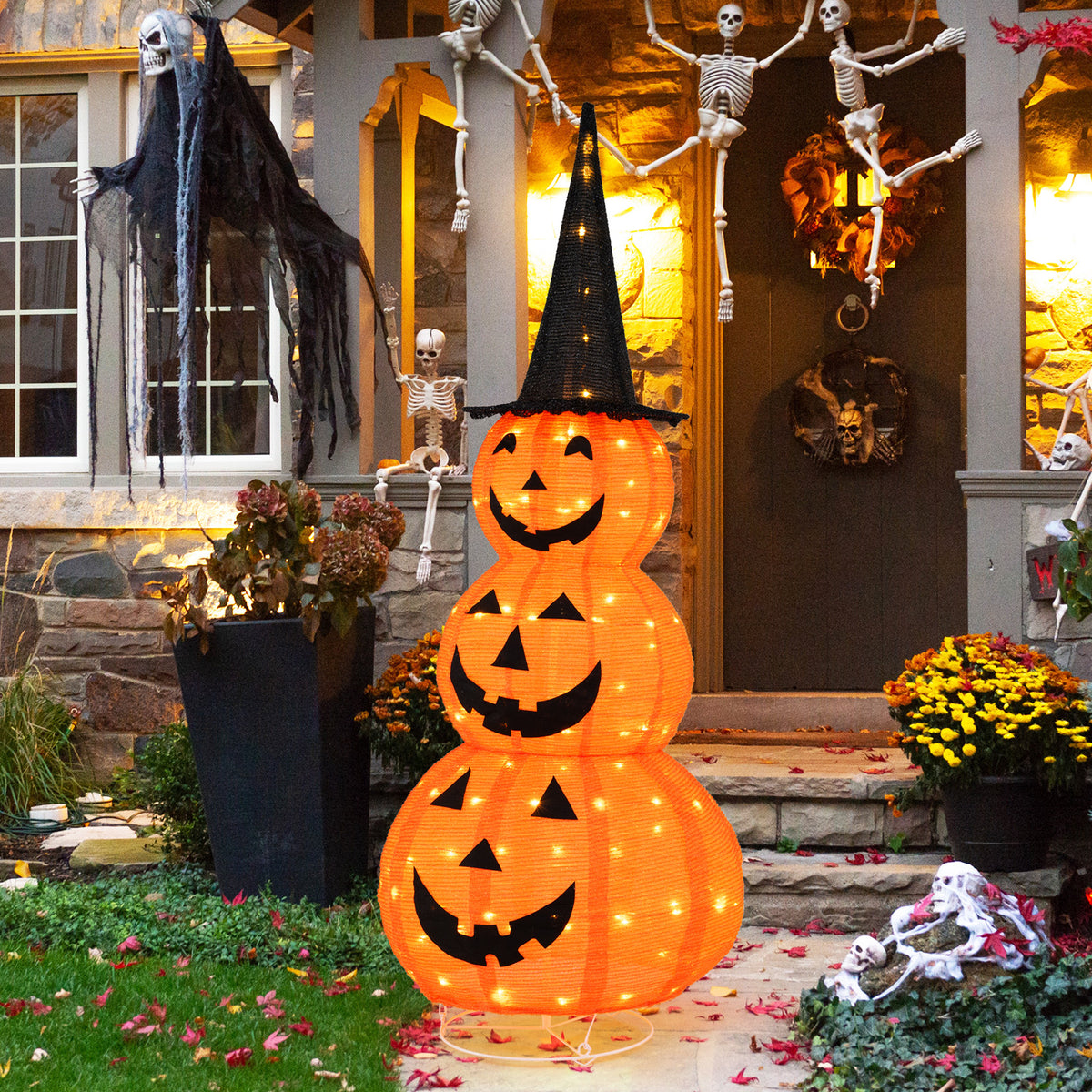 Five-foot lighted stacked pumpkin Halloween decoration with a witch hat, perfect for spooky holiday decor.