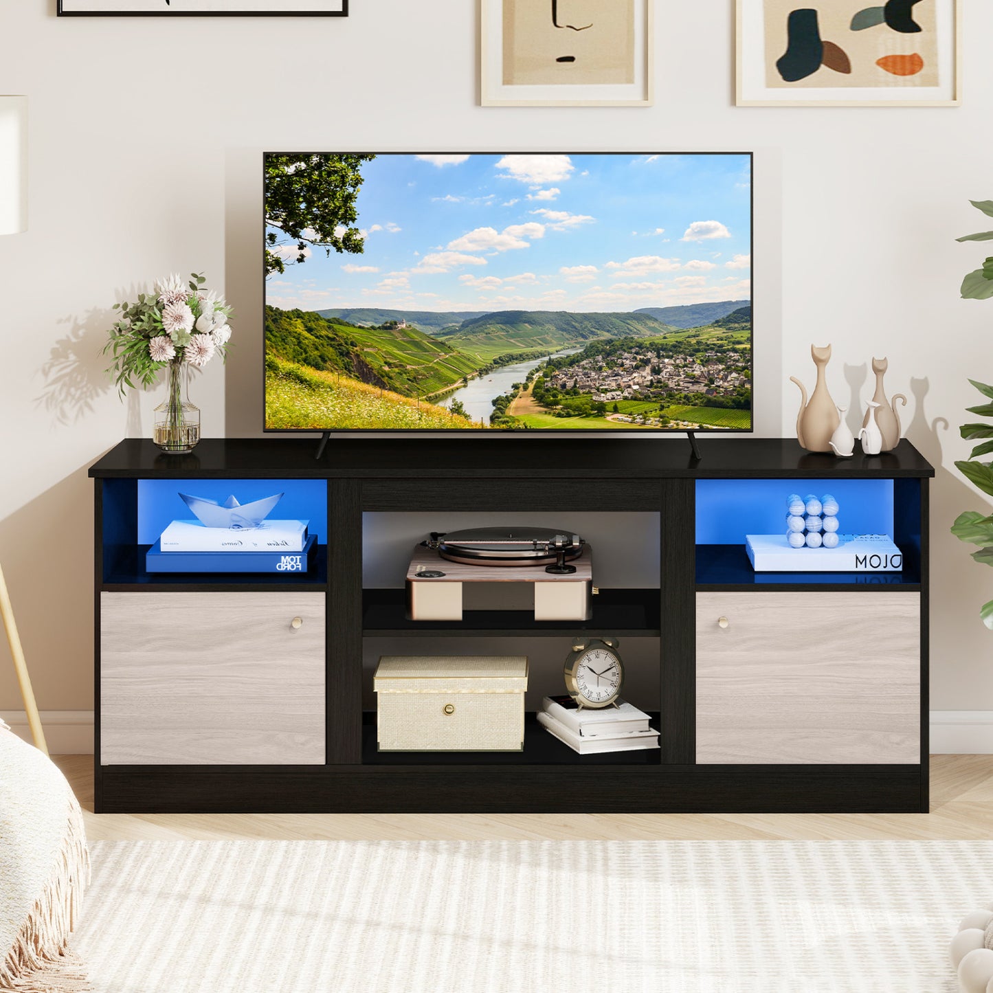 Black entertainment center with adjustable shelf and open compartment designed for 65-inch TVs, by Direct by Wilsons Home Store.
