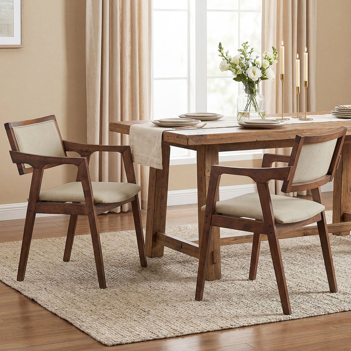 Set of two beige fabric upholstered dining chairs with rubber wood frames and arms, modern style for kitchen and dining rooms.