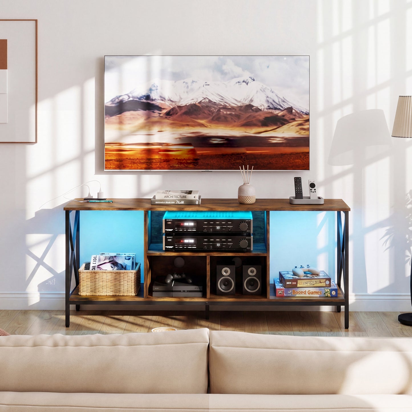 Black TV stand with LED lights for 65-inch TVs, featuring power outlets, modern entertainment center by Wilsons Home Store.