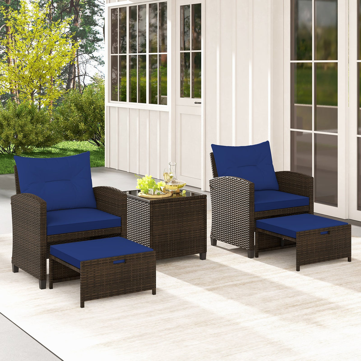 Beige 5-piece patio rattan furniture set with 2 ottomans and tempered glass coffee table for outdoor patio seating.
