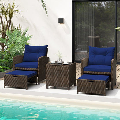 Beige 5-piece patio rattan furniture set with 2 ottomans and tempered glass coffee table, outdoor conversation set.