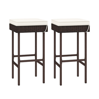Set of two outdoor rattan patio barstools with footrests and soft cushions, ideal for backyard or balcony seating.