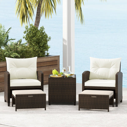 Beige 5-piece patio rattan furniture set with 2 ottomans and glass coffee table, outdoor conversation furniture.