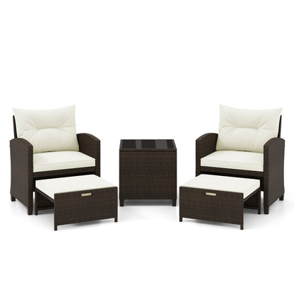 Beige 5-piece patio rattan furniture set with 2 ottomans and tempered glass coffee table for outdoor patio use.