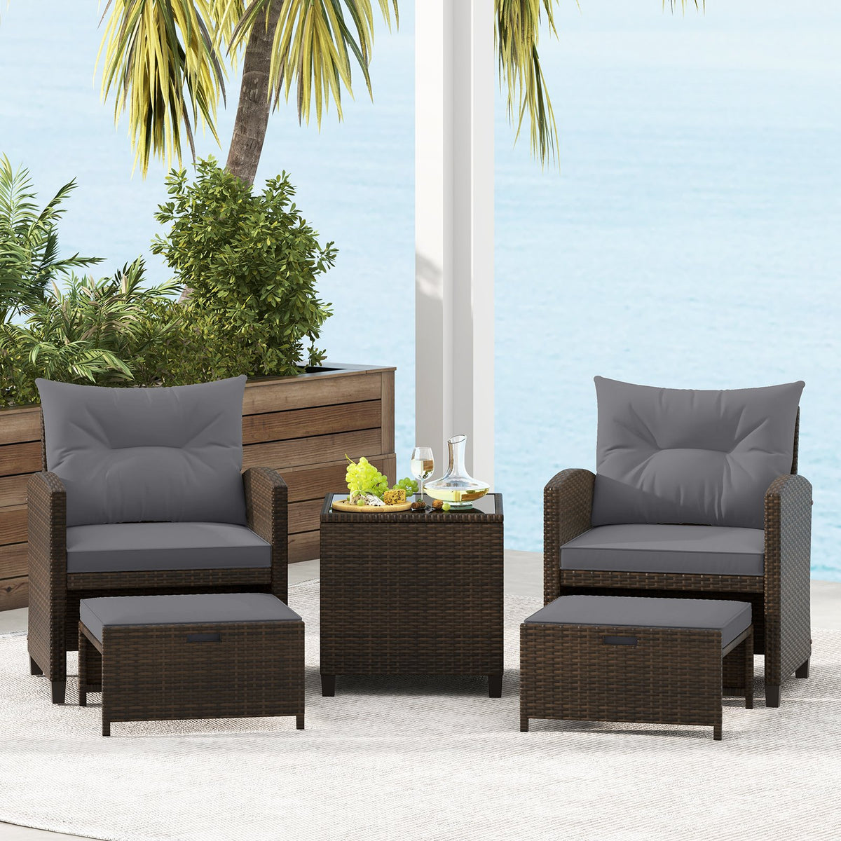 Five-piece beige patio rattan furniture set with two ottomans and a tempered glass coffee table for outdoor patio relaxation.