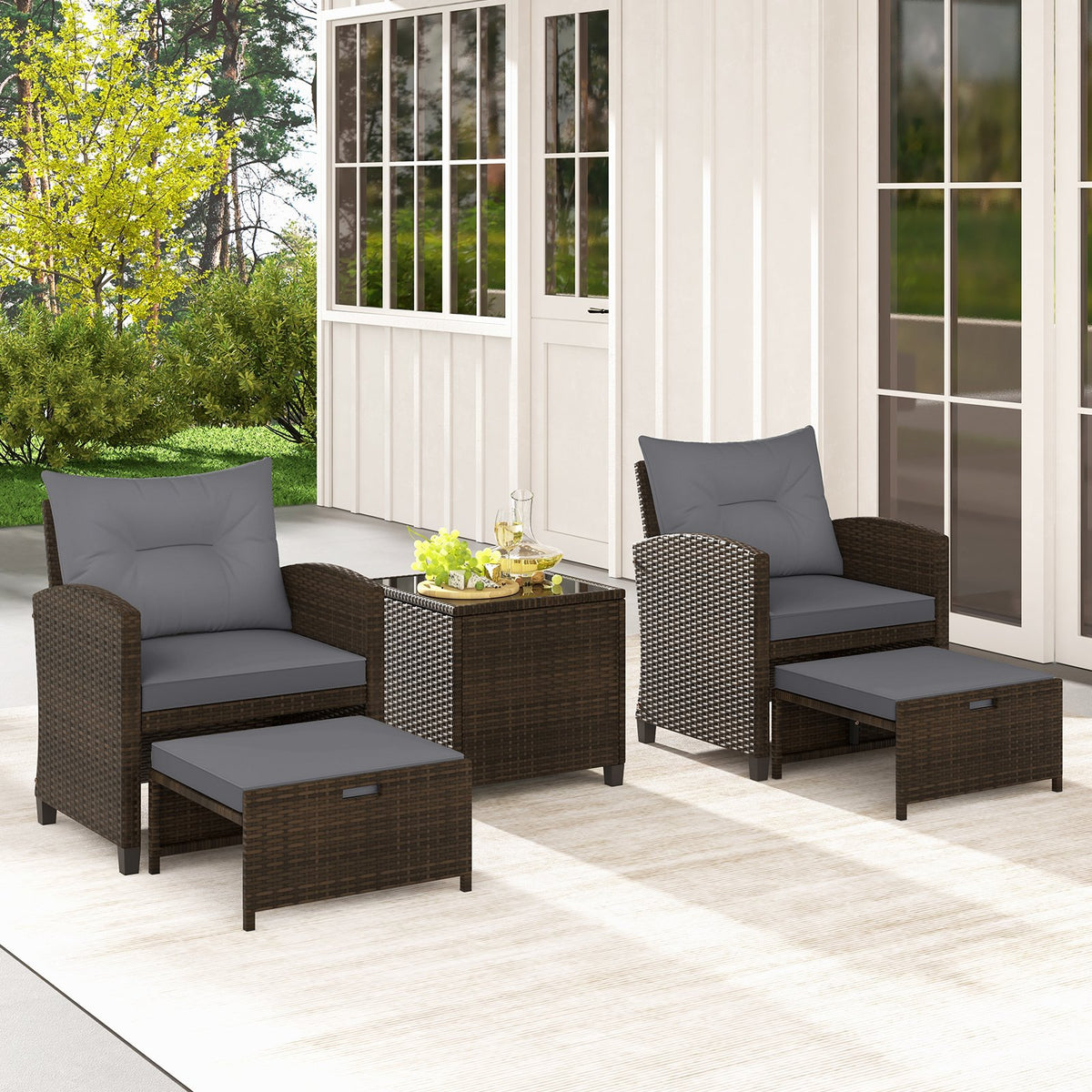 Five-piece beige patio rattan furniture set with two ottomans and a tempered glass coffee table for outdoor patio lounging.