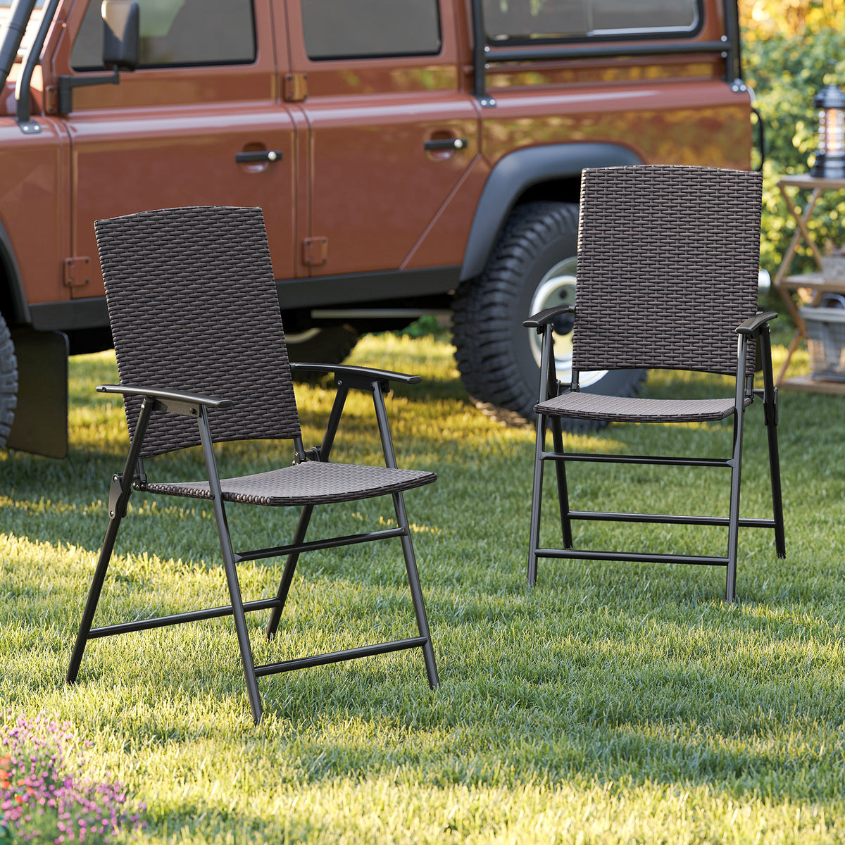 Set of two patio PE wicker dining chairs with armrests and metal frames, outdoor seating for patio dining.
