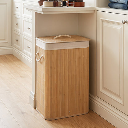 Green 19-gallon bamboo laundry hamper with removable liner and portable handles, ideal for bathroom storage.