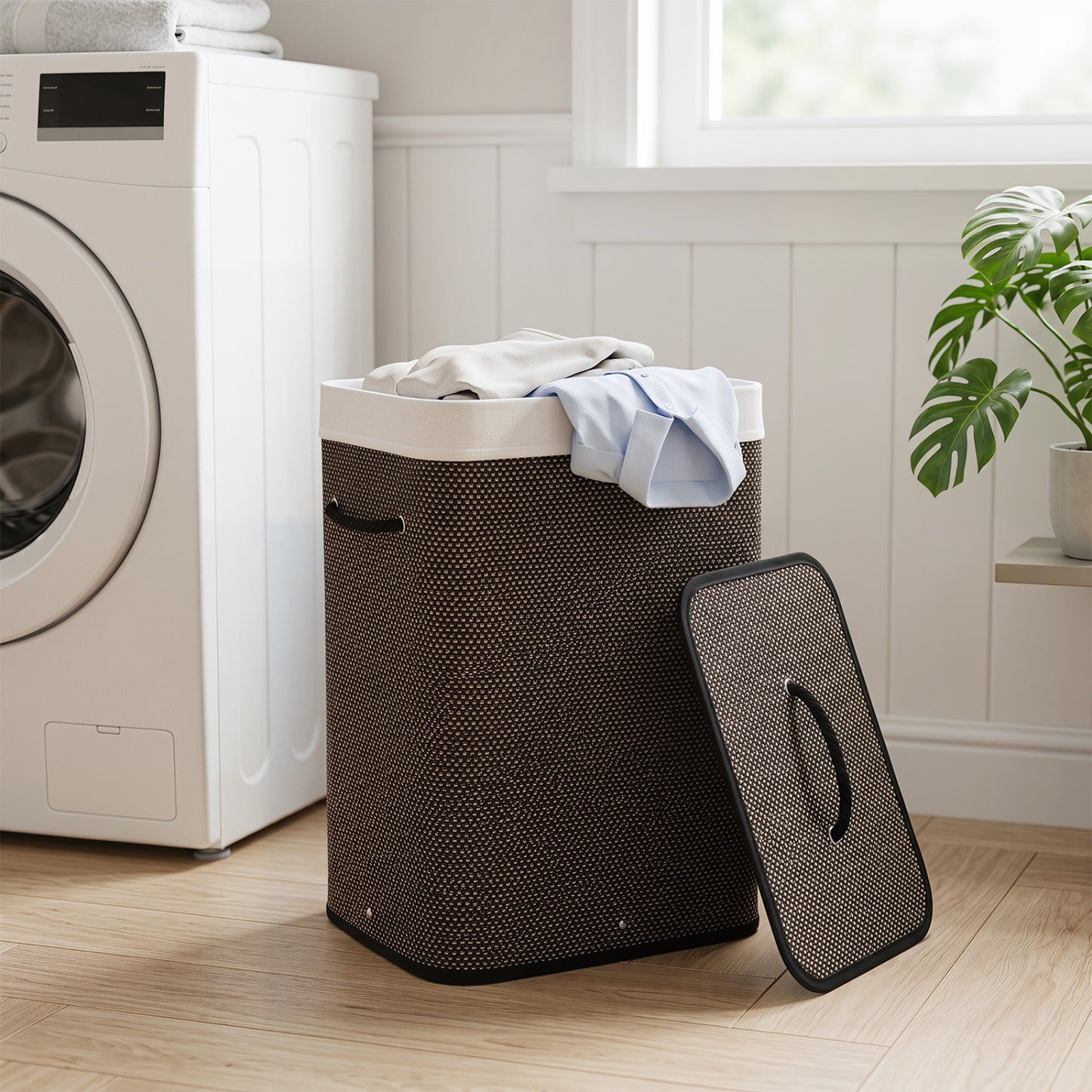 Black 19-gallon bamboo laundry hamper with removable liner and portable handles, ideal for organizing clothes in the bathroom.