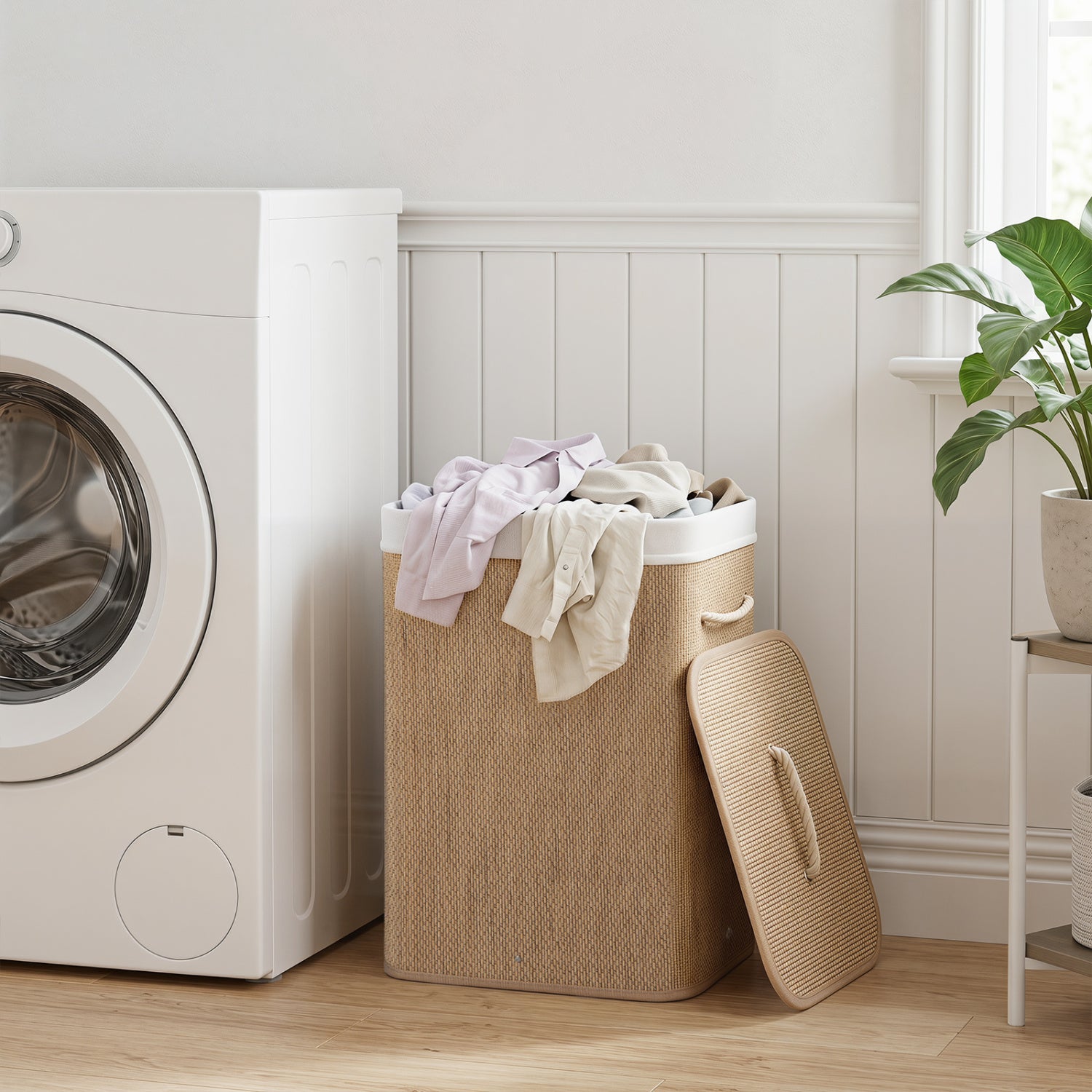 Black bamboo laundry hamper with 19-gallon capacity, removable liner, and portable handles for easy transport.