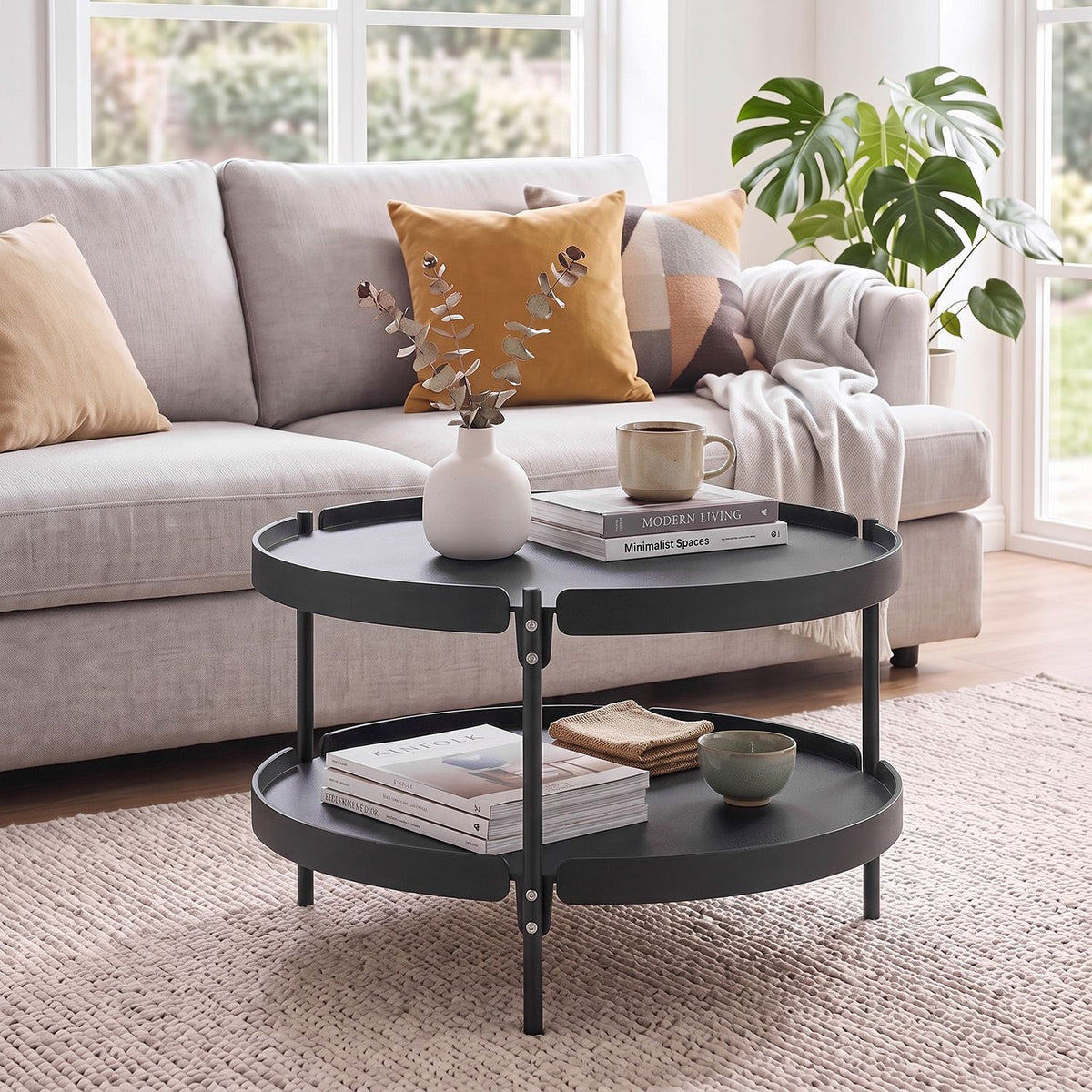 Black 24-inch round plastic coffee table with metal legs, modern living room furniture by Wilsons Home Store.