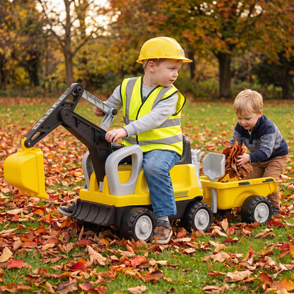 Green 2-in-1 kids ride-on tractor by Wilsons Home Store with a digging arm and detachable trailer, suitable for outdoor play.