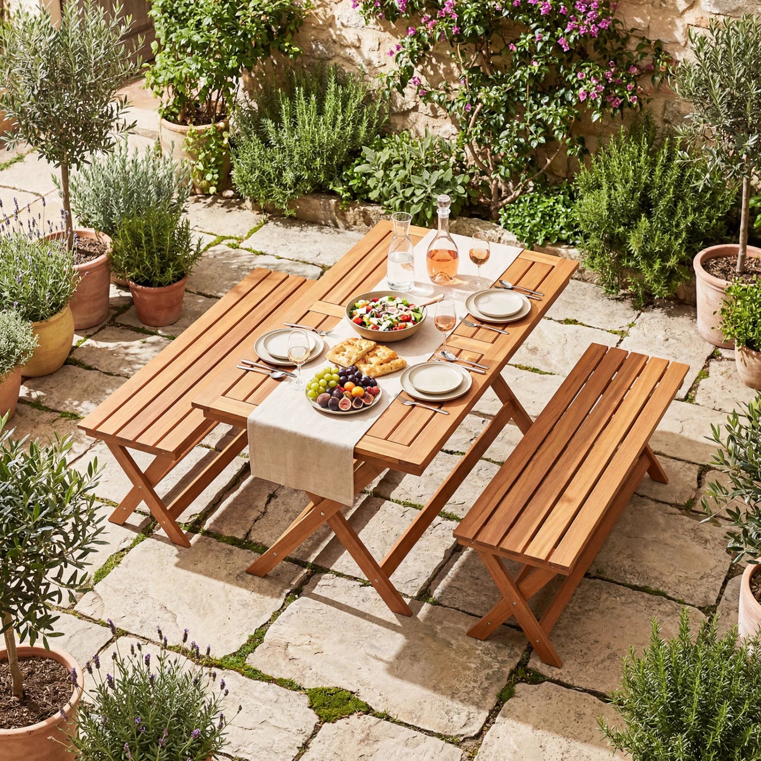 Set of two wooden garden patio benches with X-shaped legs, outdoor seating by Wilsons Home Store for backyard or patio use.