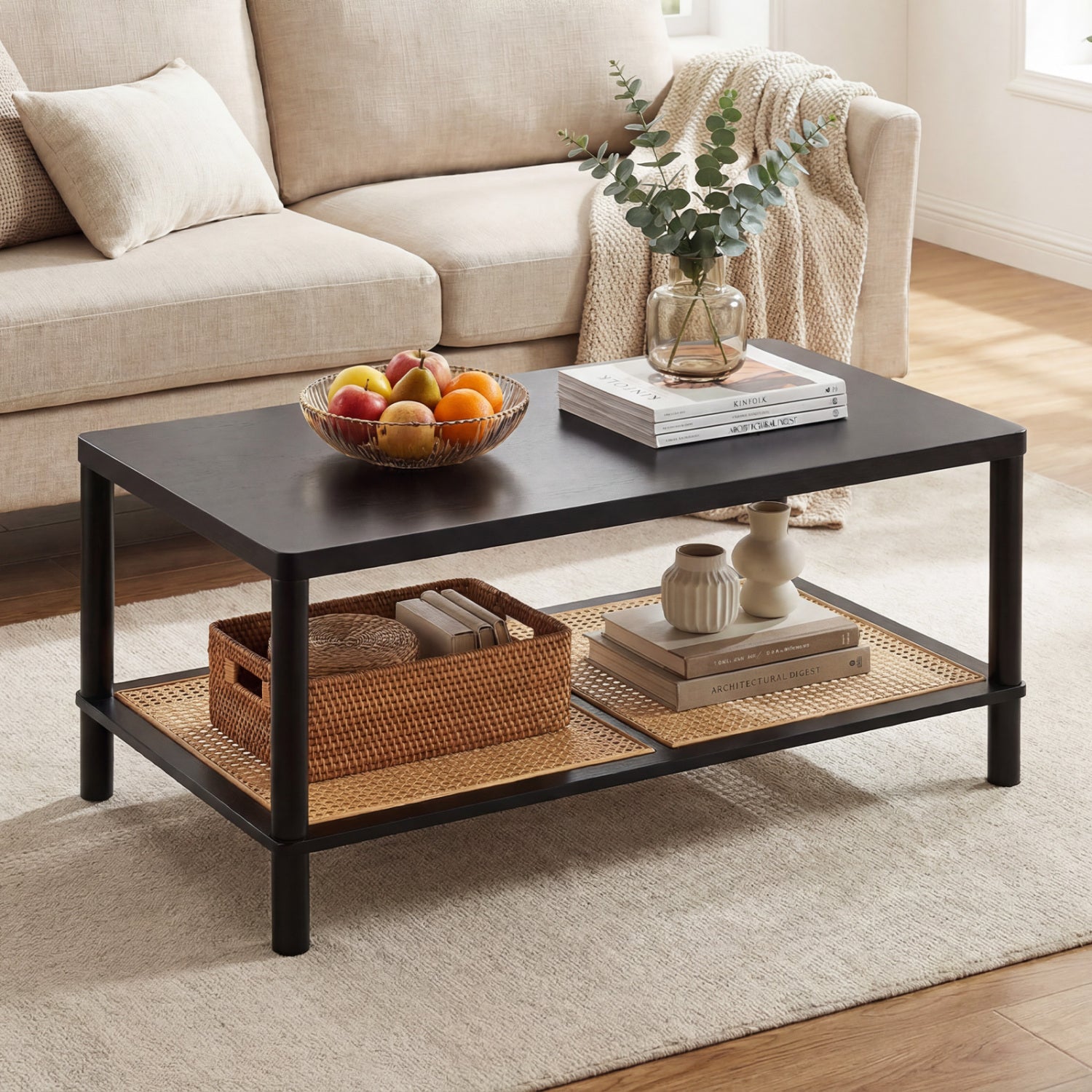 Black 2-tier boho coffee table with rubber wood frame and PVC rattan shelf for living room decor and storage.