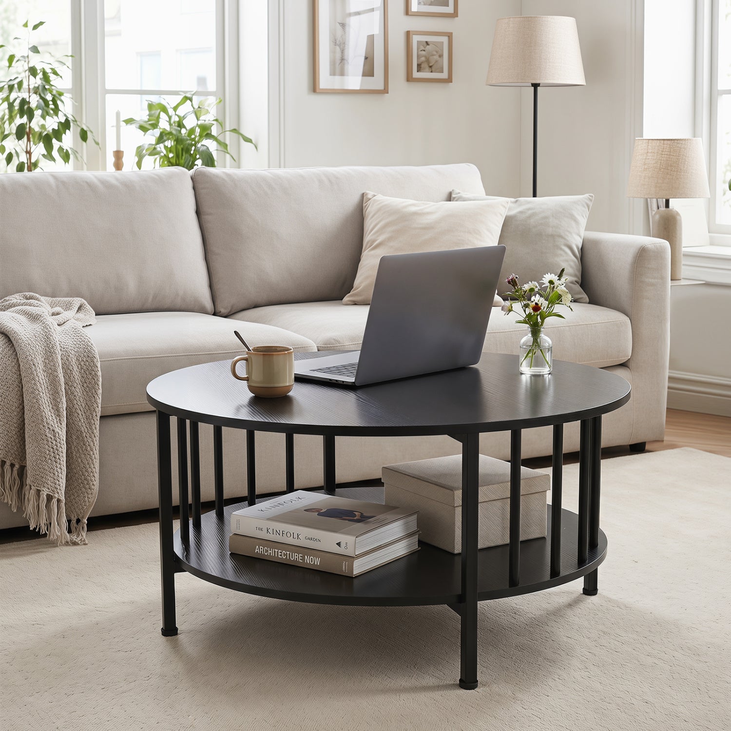 Round black walnut coffee table with two tiers, storage shelf, and metal accents for living room decor.