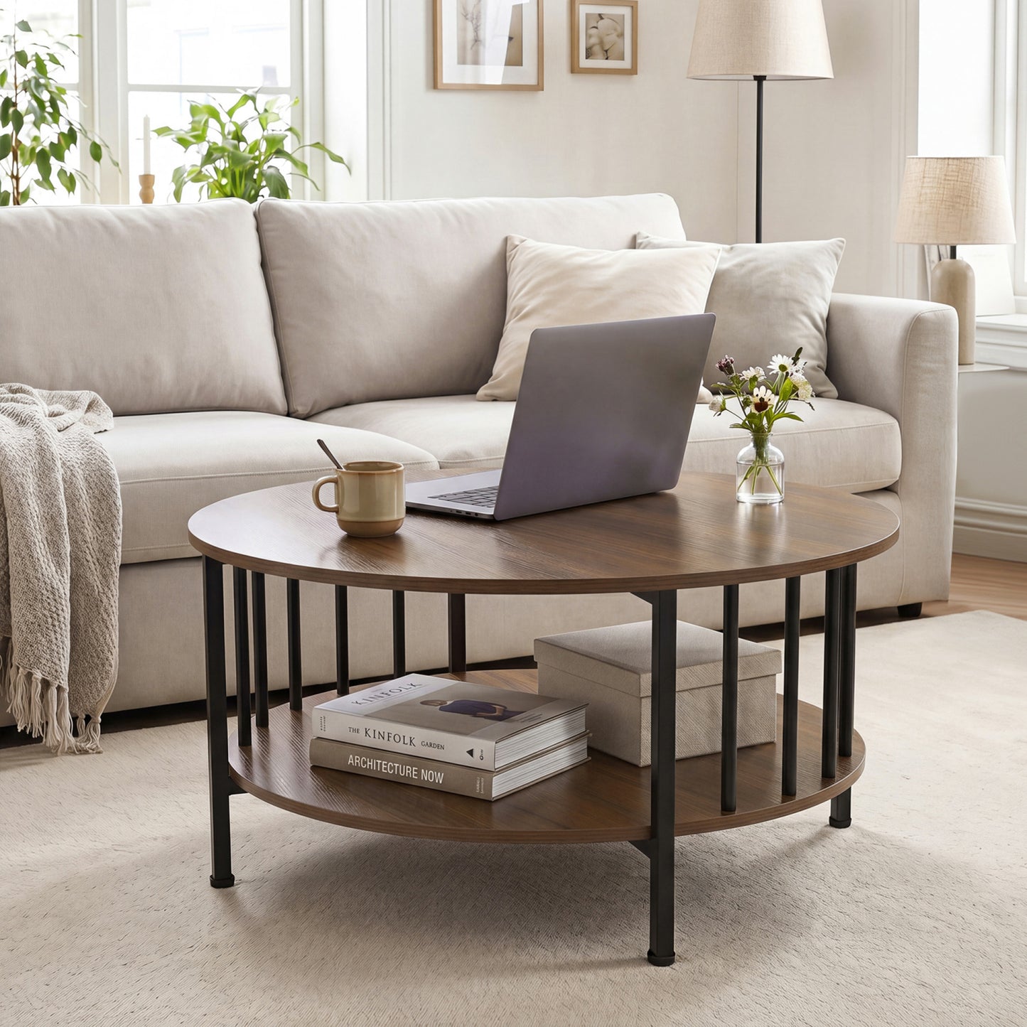 Round black walnut coffee table with two tiers and metal accents, featuring a built-in storage shelf for living room decor.