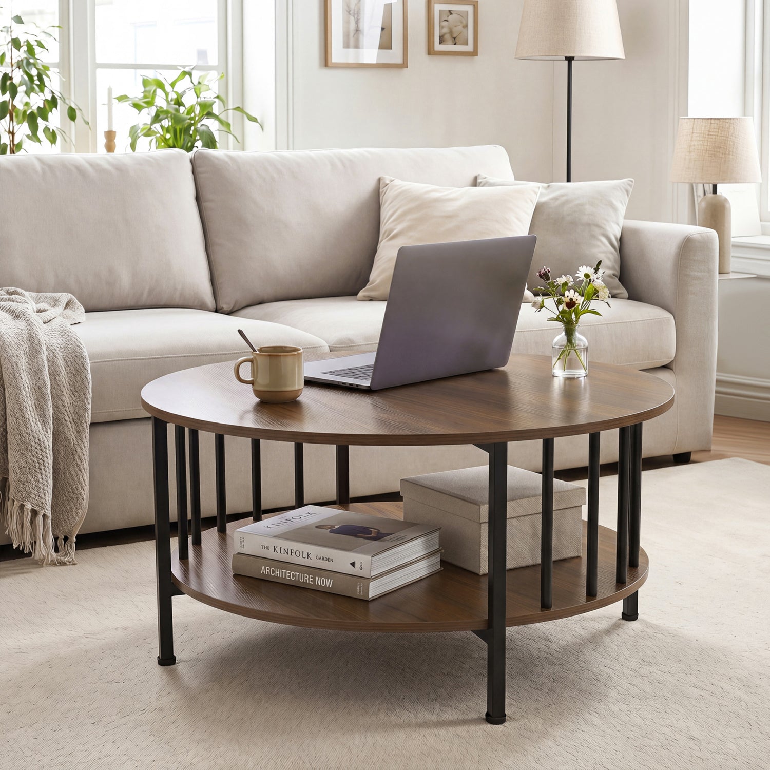 Round black walnut coffee table with two tiers and metal accents, featuring a built-in storage shelf for living room decor.