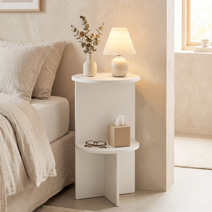 White 2-tier round side table with storage shelf by Wilsons Home Store, designed for small living spaces.
