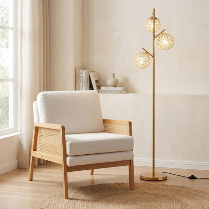 Modern 3-globe floor lamp and mid-century accent chair in a stylish living room setting, featuring warm lighting and contemporary decor.