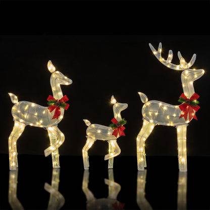 Three white lighted reindeer Christmas yard decor set, featuring a family of reindeer figures for holiday outdoor decoration.