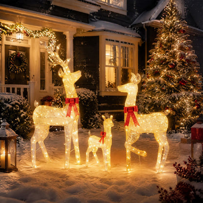 Three lighted golden Christmas reindeer figures forming a family set, decorative holiday decor for Christmas celebrations.