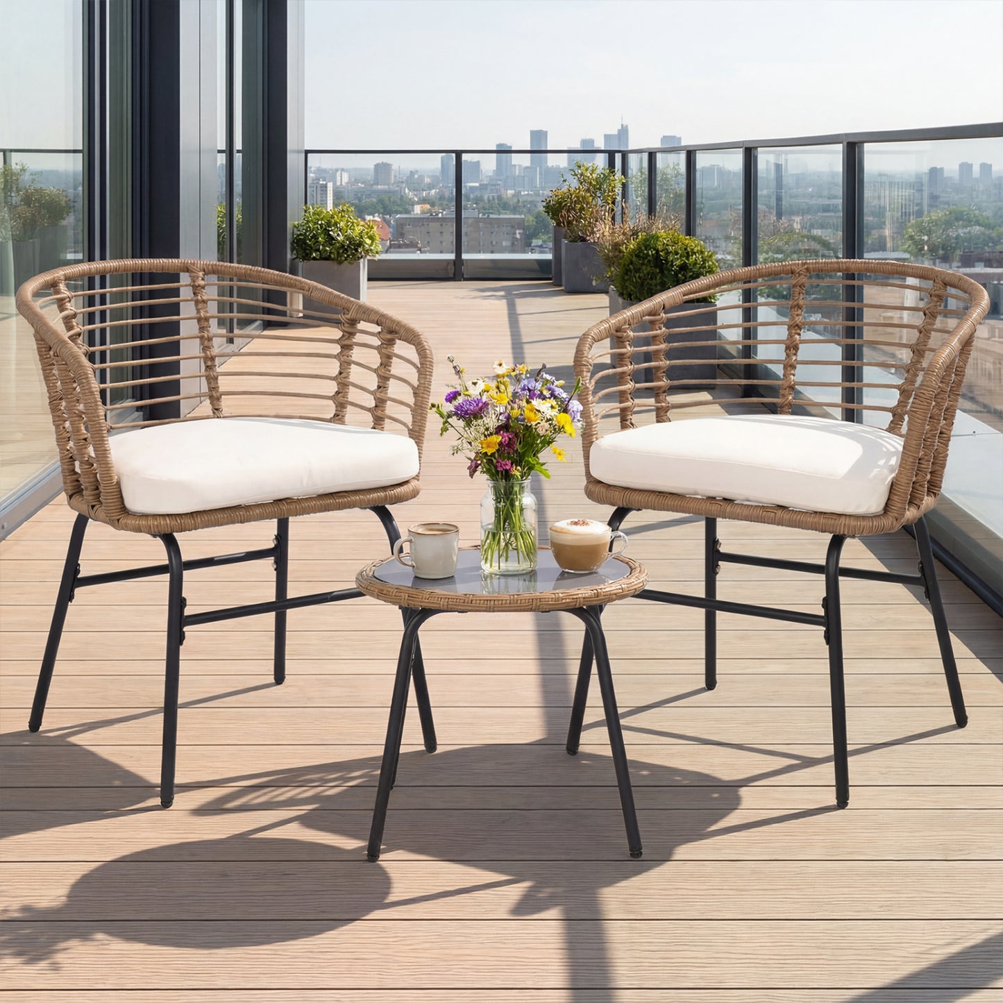 Three-piece outdoor patio furniture set with white cushions, including chairs and a table, by Wilsons Home Store.