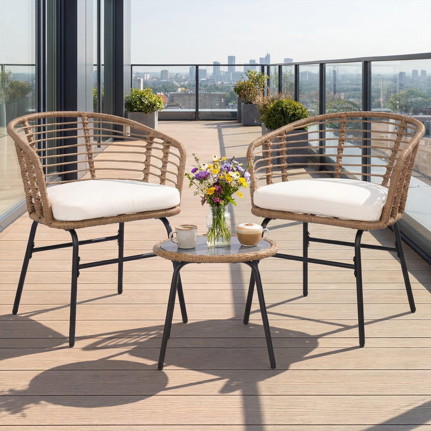 Three-piece outdoor patio furniture set with white cushions, including chairs and a table, by Wilsons Home Store.