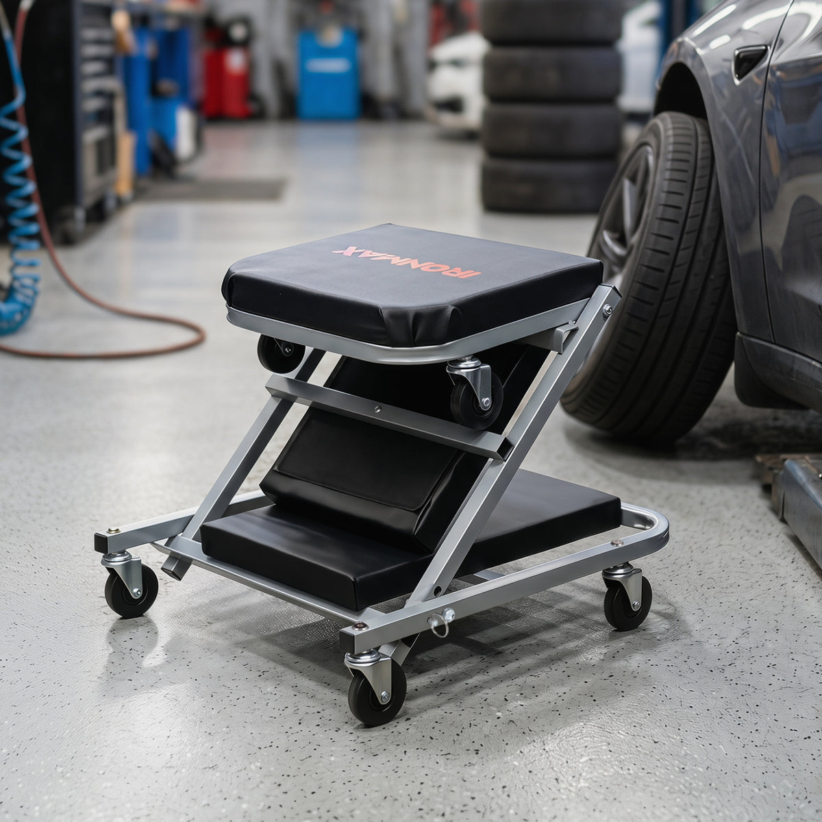 Black 40-inch 2-in-1 mechanic creeper and Z-seat with six swivel casters, designed for outdoor garage and storage use.