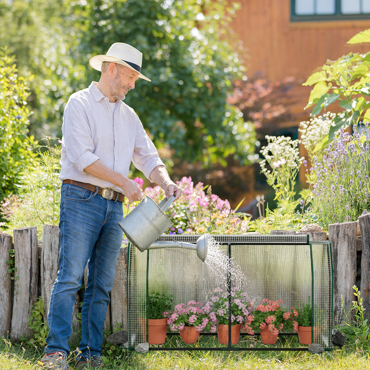 Outdoor portable mini greenhouse with PE cover and zippered door, ideal for vegetables, by Wilsons Home Store.