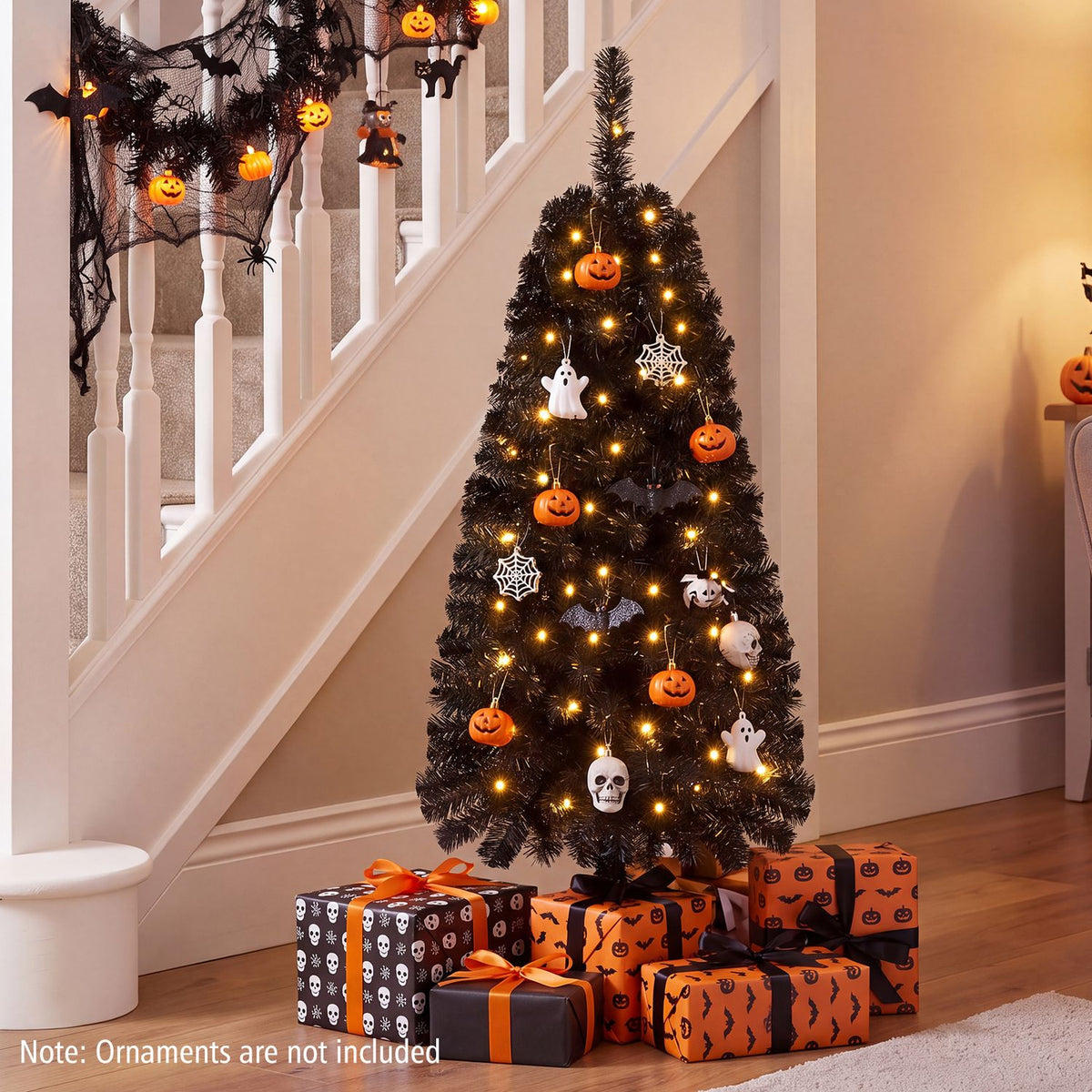 4 ft black artificial Christmas tree with 110 branch tips and 50 warm white LED lights for holiday decor.