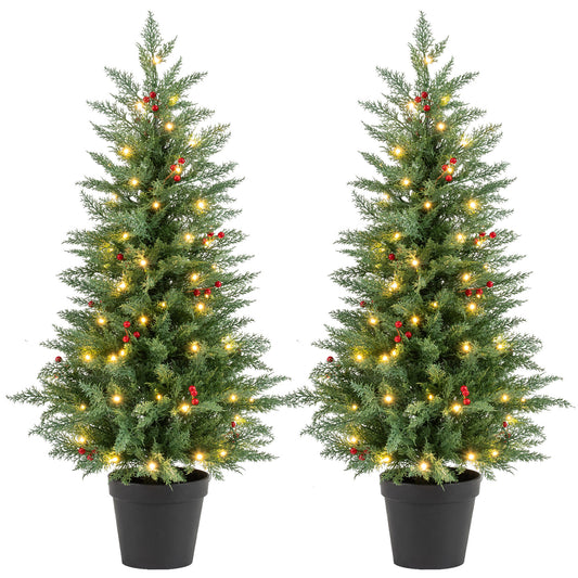 Two 4-foot pre-lit Christmas trees with warm white LED lights and 173 branch tips each, ideal for holiday decor.