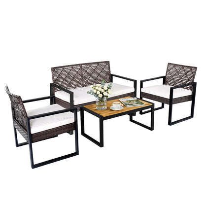 4-piece outdoor patio set with acacia coffee table and wicker chairs in brown and black, ideal for backyard relaxation.