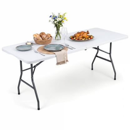 White 6 ft plastic fold-in-half camping table by Wilsons Home Store, outdoor patio table with foldable design for camping and outdoor use.