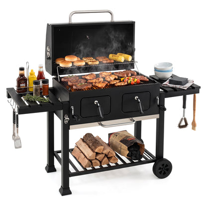 Large charcoal outdoor grill by Wilsons Home Store with lifting charcoal trays, folding tables, and wheels for easy mobility.