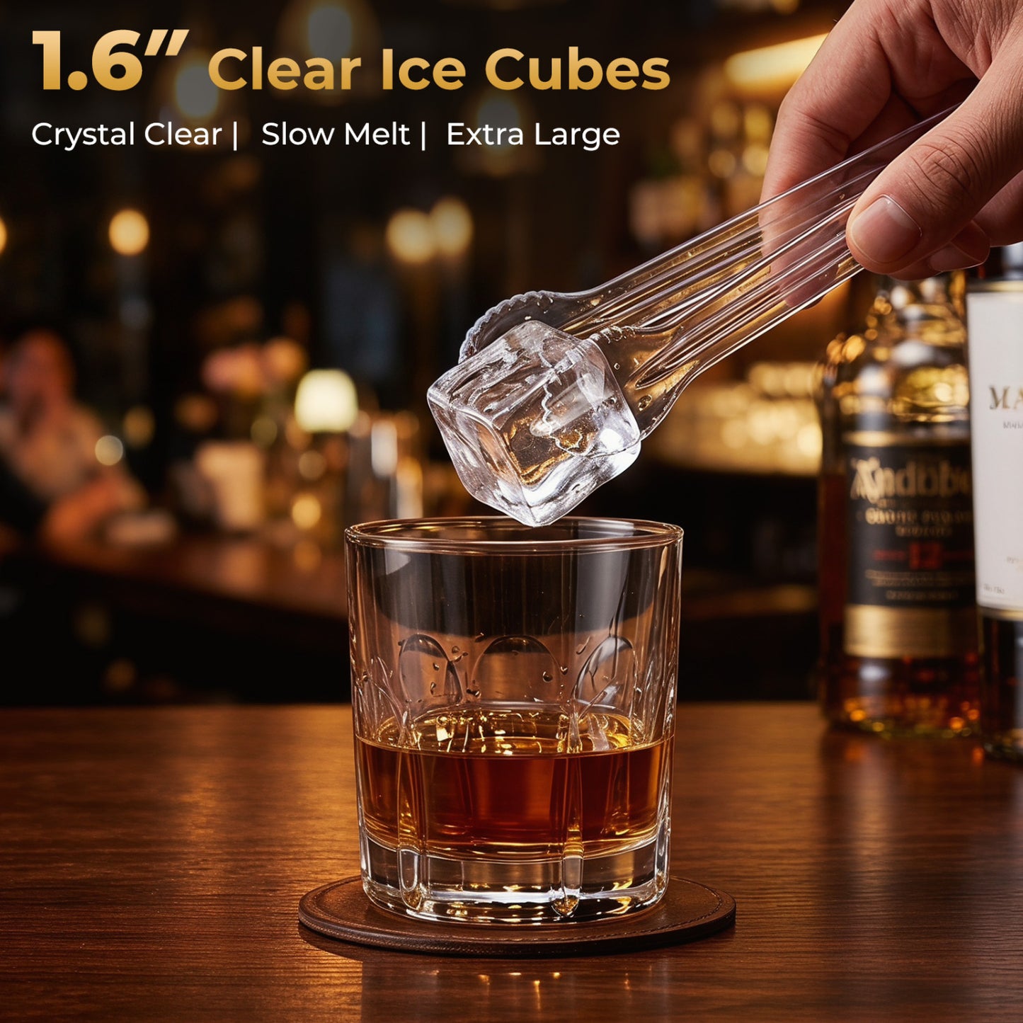 Silver countertop ice cube maker producing large 1.6-inch clear square ice cubes for kitchen use.