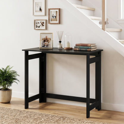 Black folding console table with foldable legs, ideal for entryways, from Wilsons Home Store.