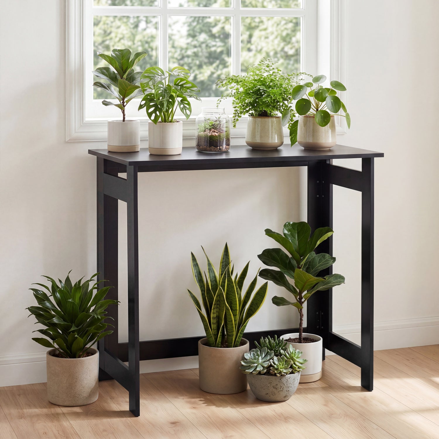 Black folding console table with foldable legs, designed for entryway or small space furniture, by Wilsons Home Store.