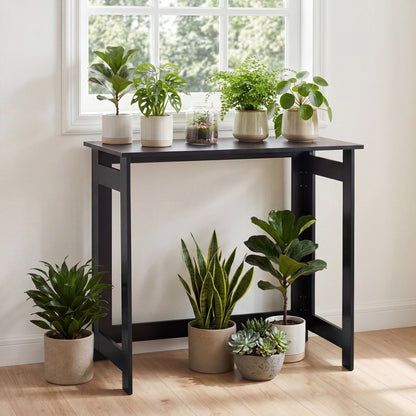 Black folding console table with foldable legs, designed for entryway or small space furniture, by Wilsons Home Store.