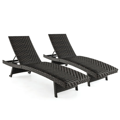 Set of two folding padded rattan patio chaise lounges with adjustable backrests for outdoor relaxation.
