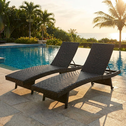 Pair of folding padded rattan patio chaise lounges with adjustable backs, ideal for outdoor patio seating.