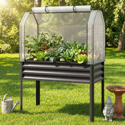 Galvanized steel raised garden bed with legs and green greenhouse cover for vegetables and flowers in outdoor garden setting