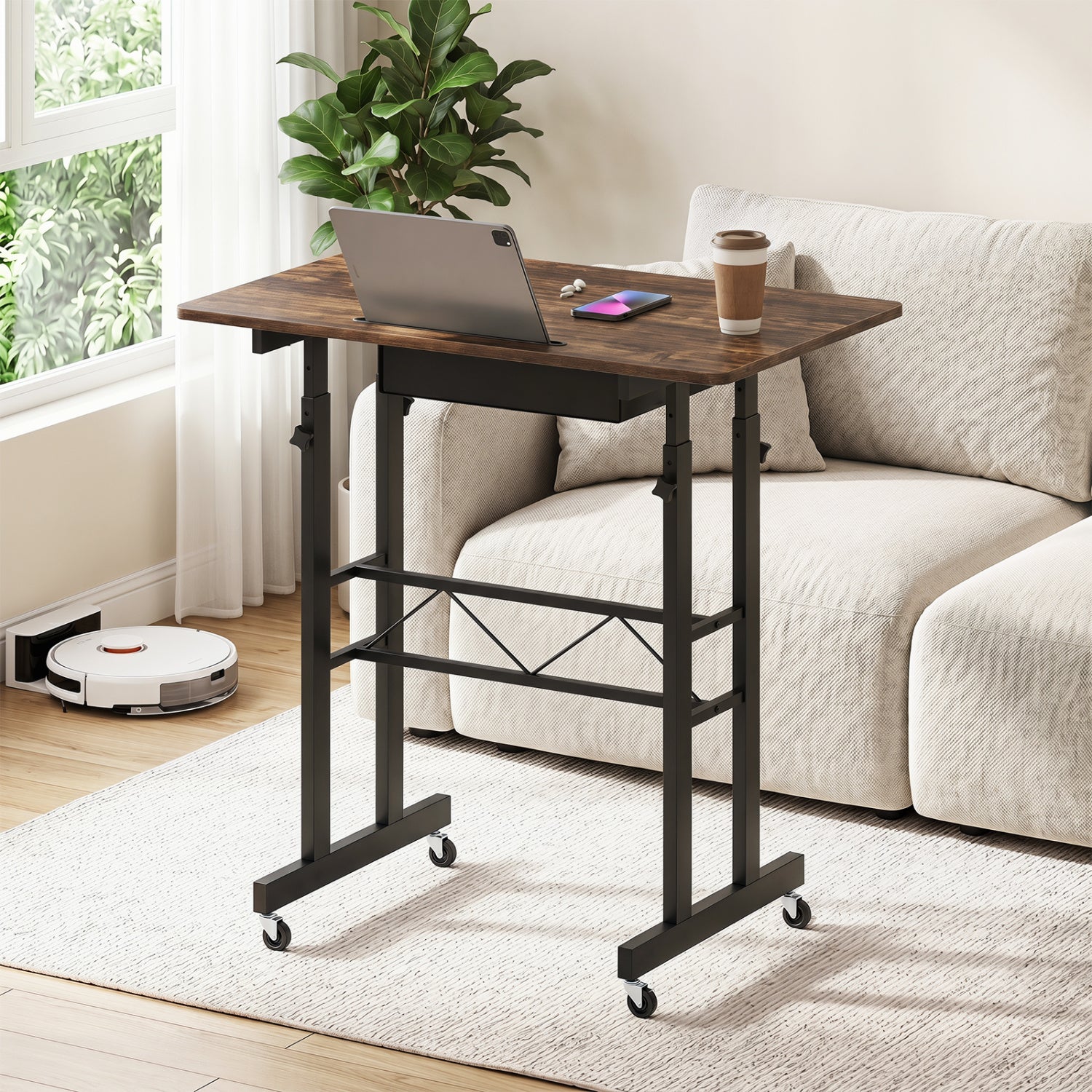 Black height adjustable laptop desk with fabric drawer, tablet holder, and lockable wheels for versatile home office use.