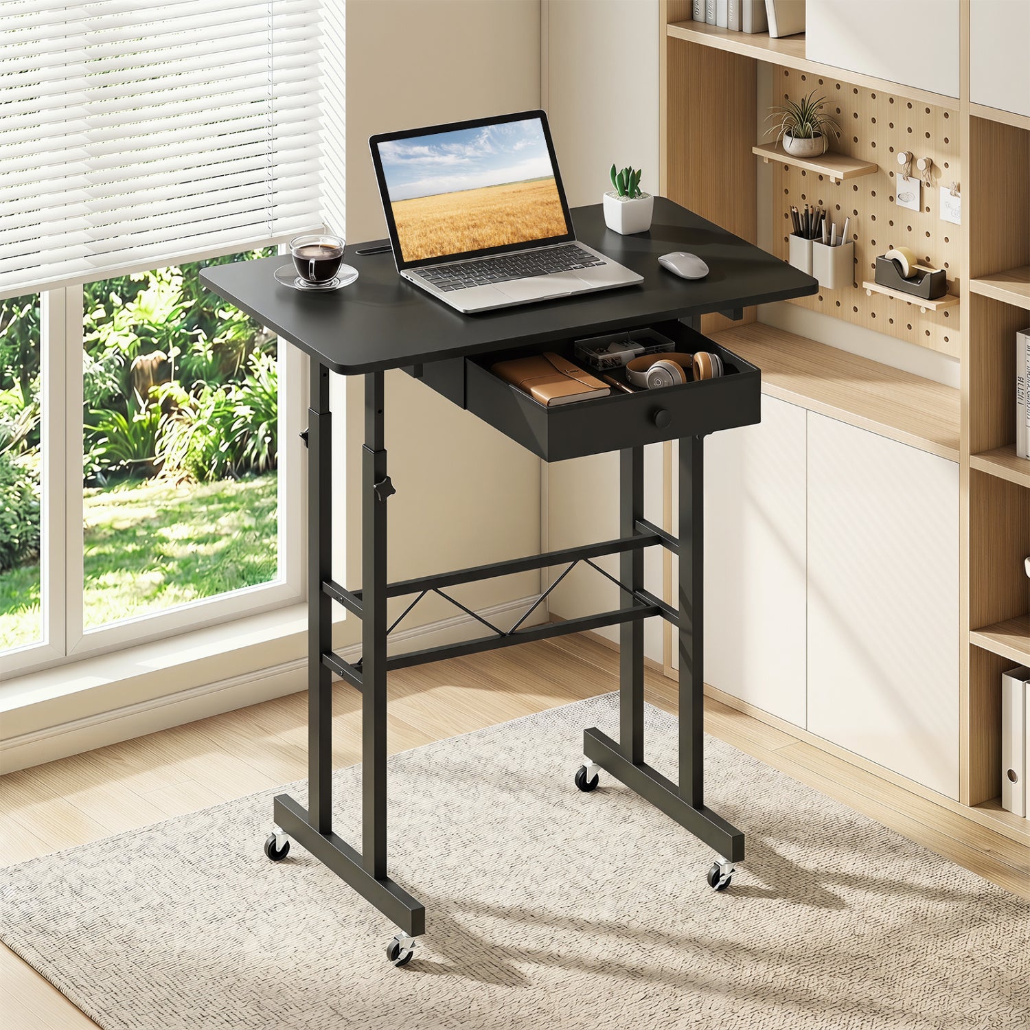 Black height adjustable laptop desk with fabric drawer, tablet holder, and lockable wheels, suitable for home office use.