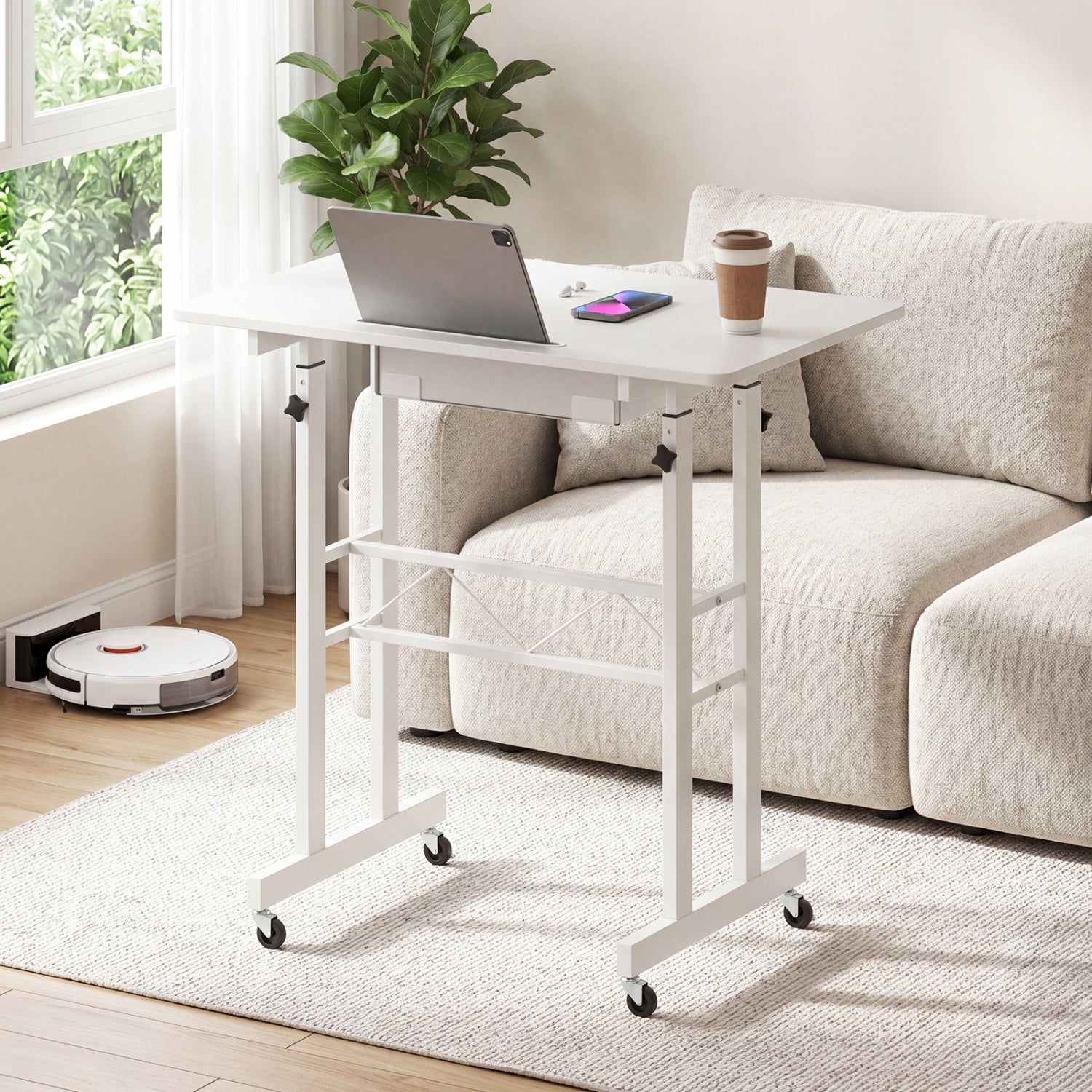 Black height adjustable laptop desk with fabric drawer, tablet holder, and lockable wheels for versatile home office use.