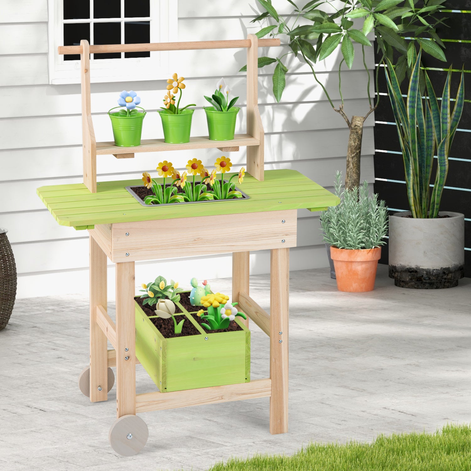 Kids mud kitchen with removable pots, watering can, planting trough, and storage box for outdoor pretend play.