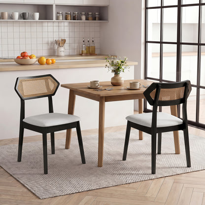 Set of two mid-century rattan dining chairs with rattan backs and solid wood frames in black, by Wilsons Home Store.
