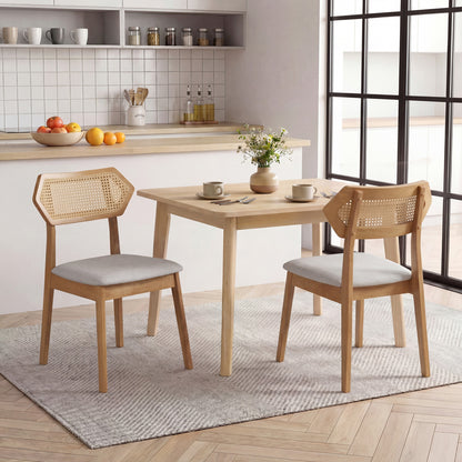 Set of two mid-century rattan dining chairs with rattan backs and solid wood frames by Wilsons Home Store, black finish.