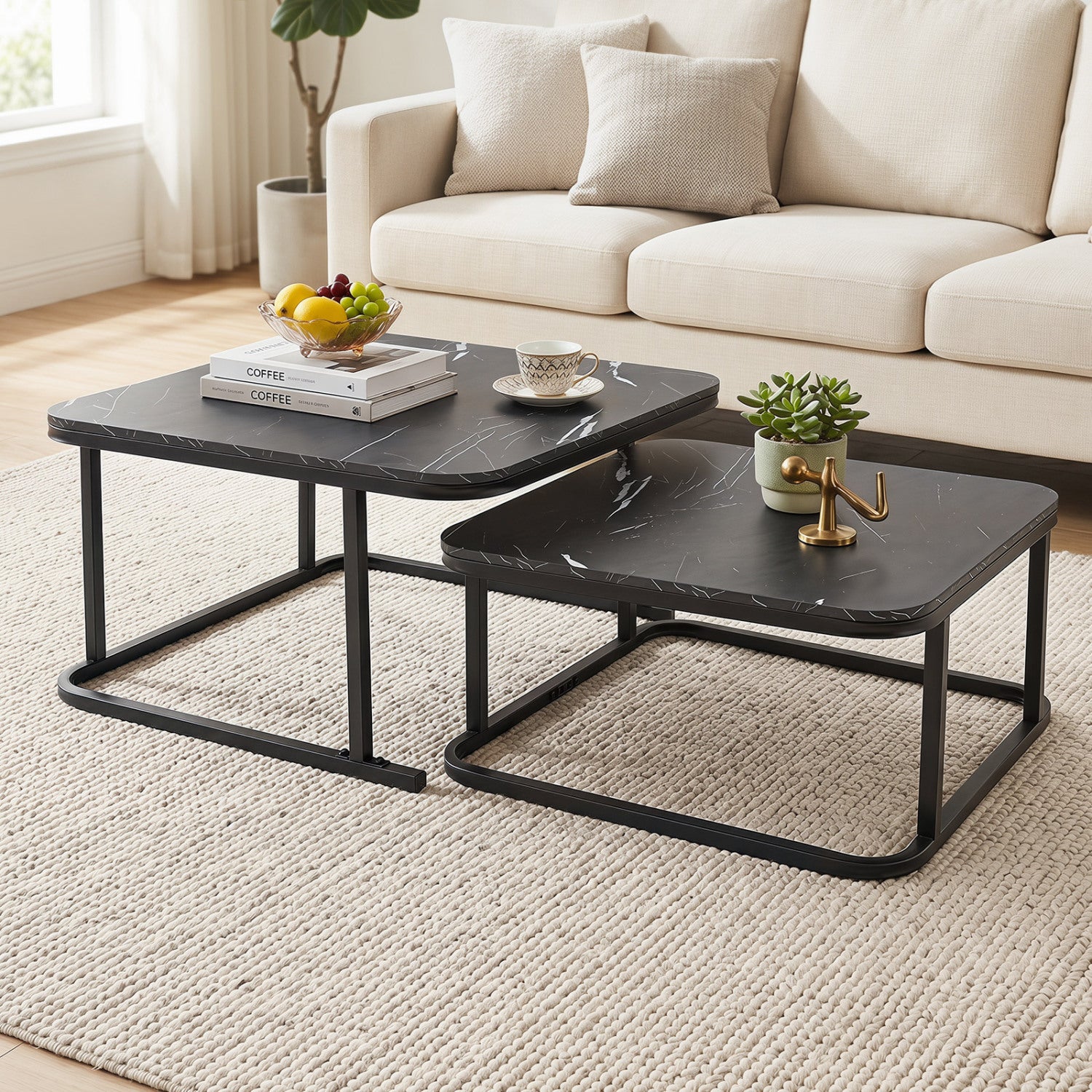 Set of two nesting coffee tables with faux marble tops and black metal frames for living room decor.